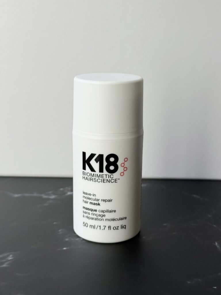 White k18 bottle on a dark marble surface